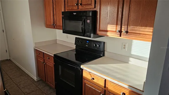 a kitchen with a stove microwave and sink