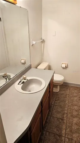 a bathroom with a sink a toilet and a mirror