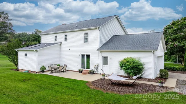 a view of a backyard with plants and a patio