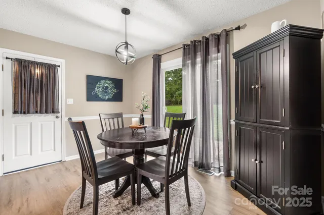 a dining room with furniture window and wooden floor