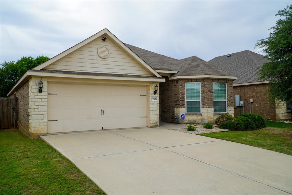 13624 Helix Bridge Way Crowley, TX 76036 - Photo 2 of 25 a front view of a house with a yard and garage