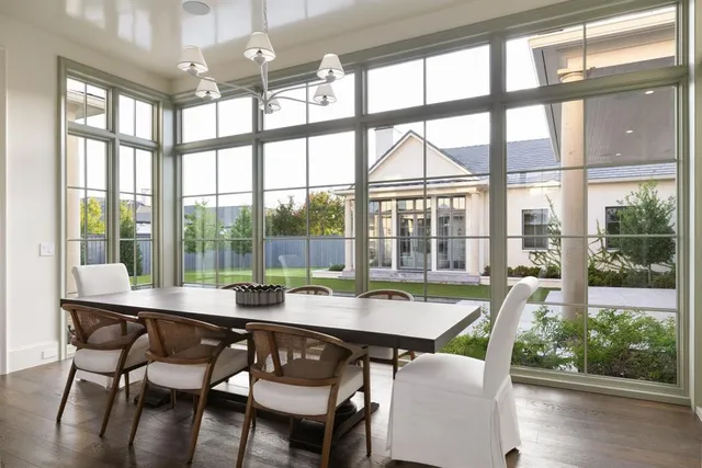 a dining room with furniture window and wooden floor