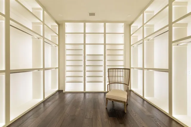 a view of walk in closet with wooden floor
