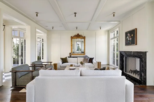 a living room with furniture large window and fireplace