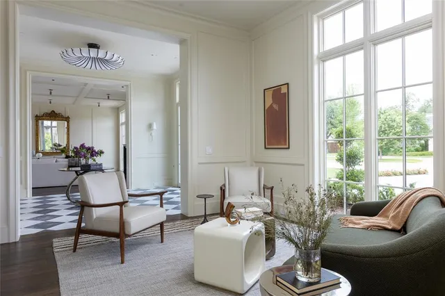 a living room with furniture and floor to ceiling windows