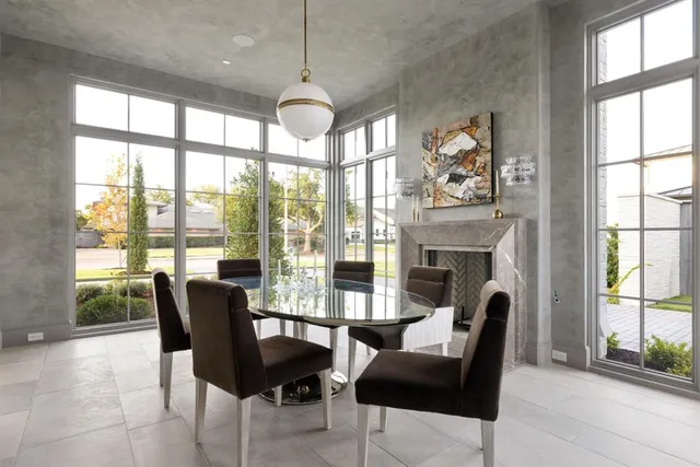 a view of a dining room with furniture large windows and wooden floor