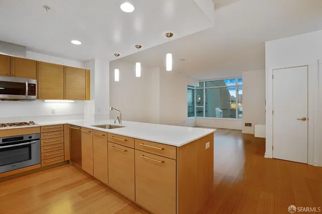 a kitchen with sink cabinets and appliances
