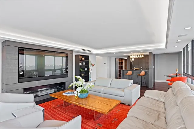 a spacious bedroom with a bed and glass walk in closet