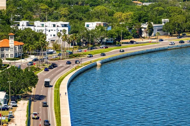 a bathroom with a granite countertop sink a mirror and shower