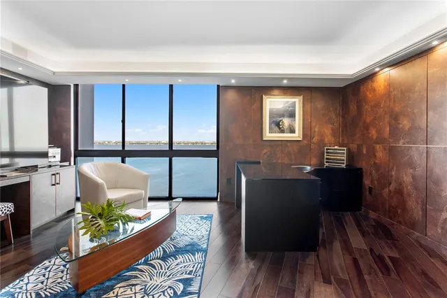 a view of a dining room with furniture wooden floor and chandelier
