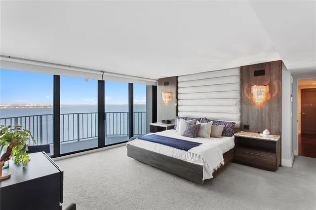 a view of a dining room with furniture a chandelier and wooden floor