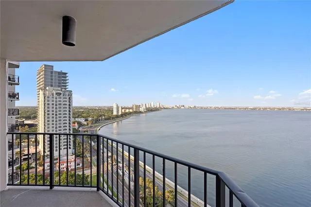 a kitchen with granite countertop a sink a counter top space and living room area