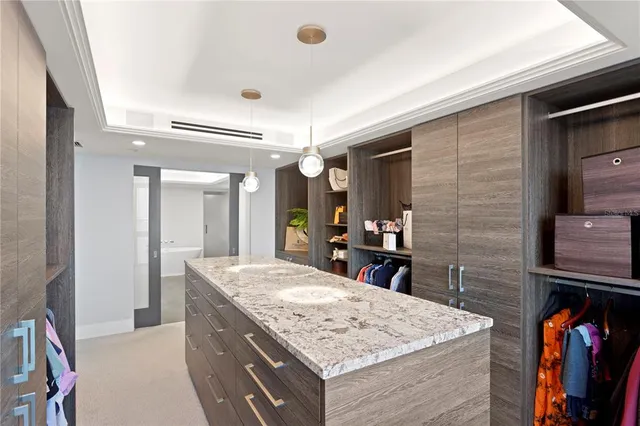 a kitchen with stainless steel appliances granite countertop a sink a stove and cabinets