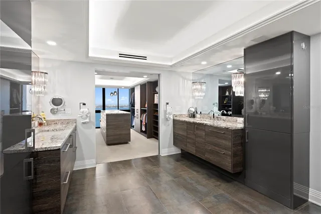 a bathroom with a granite countertop sink and a shower