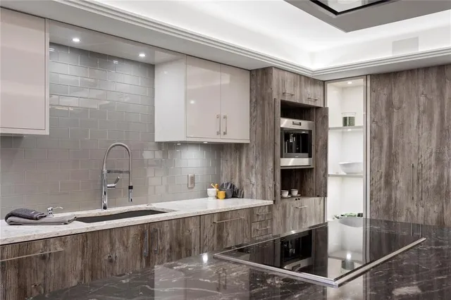 a bathroom with a sink a light fixture and a mirror