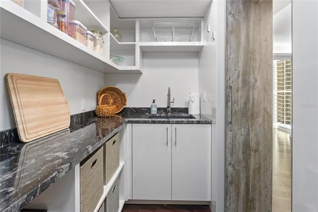 a bathroom with a granite countertop sink mirror vanity and toilet