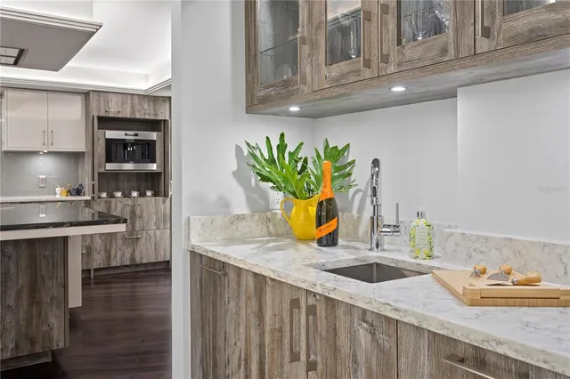 a view of a hallway with furniture and wooden floor