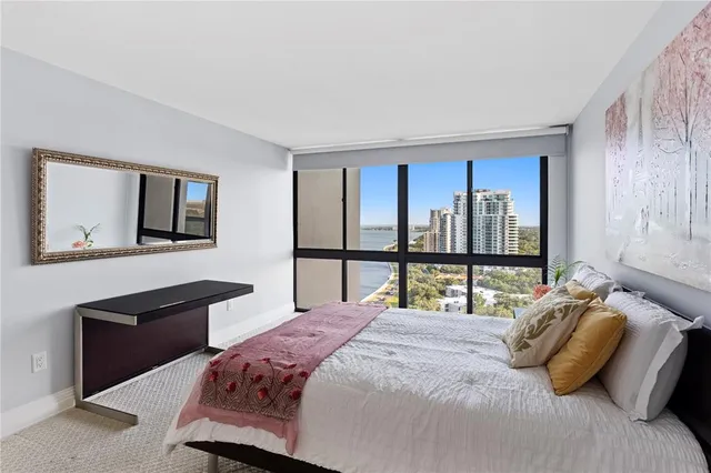 a living room with furniture a rug and white walls