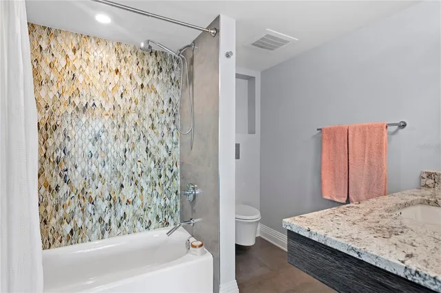 a large kitchen with stainless steel appliances kitchen island granite countertop a sink and cabinets