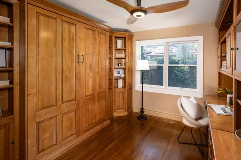 a view of a livingroom with furniture window and wooden floor
