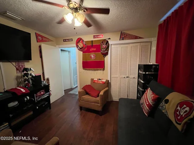 a living room with furniture a rug and a flat screen tv