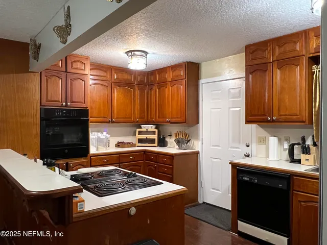 a kitchen with a sink refrigerator and cabinets