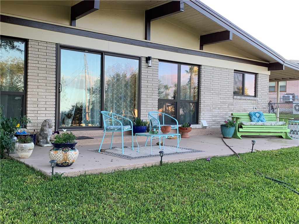 143 Trail Ridge Drive Sandia, TX 78383 - Photo 2 of 40 a view of a patio with table and chairs potted plants and large tree