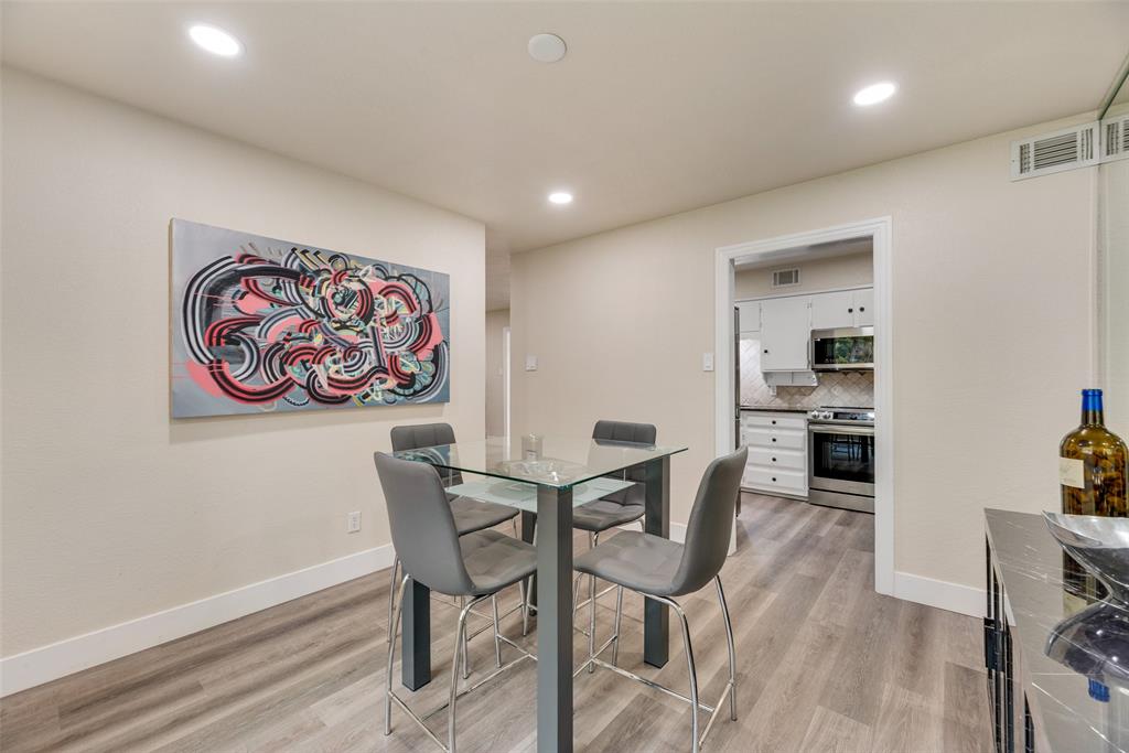 61 1 Main Place Benbrook, TX 76126 - Photo 11 of 21 a view of a dining room with furniture and wooden floor