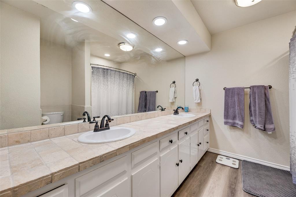 61 1 Main Place Benbrook, TX 76126 - Photo 16 of 21 a bathroom with a double vanity sink and a mirror