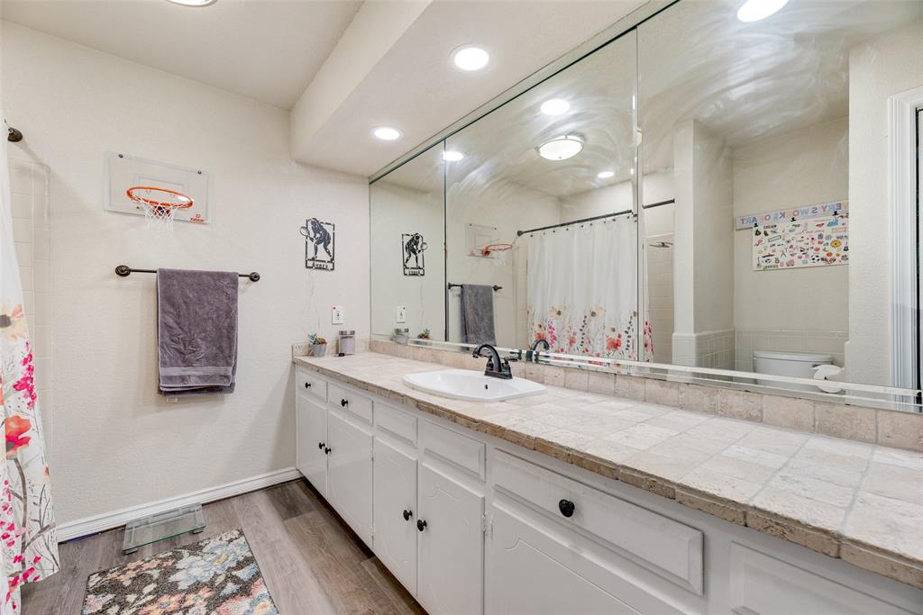 61 1 Main Place Benbrook, TX 76126 - Photo 18 of 21 a bathroom with a sink double vanity and a mirror