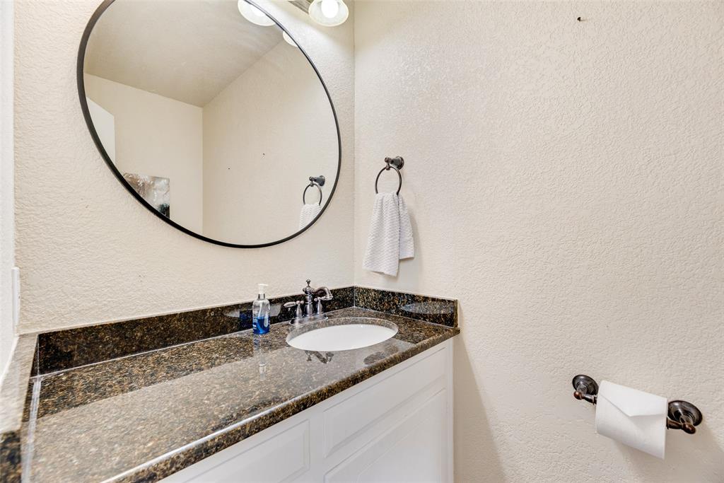 61 1 Main Place Benbrook, TX 76126 - Photo 19 of 21 a bathroom with a granite countertop sink and a mirror