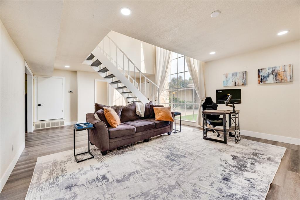 61 1 Main Place Benbrook, TX 76126 - Photo 7 of 21 a living room with furniture a large window and a flat screen tv