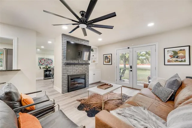 a living room with furniture a fireplace and a flat screen tv