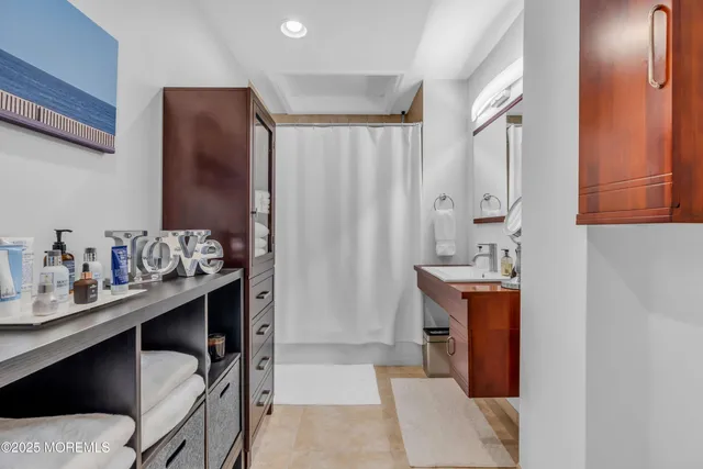 a kitchen with a sink refrigerator and cabinets
