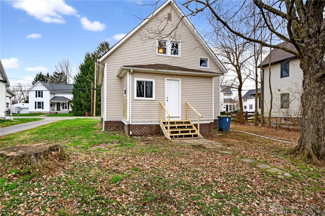 585 North Spring Street Wilmington, OH 45177 - Photo 21 of 21 This charming home offers a cozy retreat with classic siding and a welcoming back entrance.
