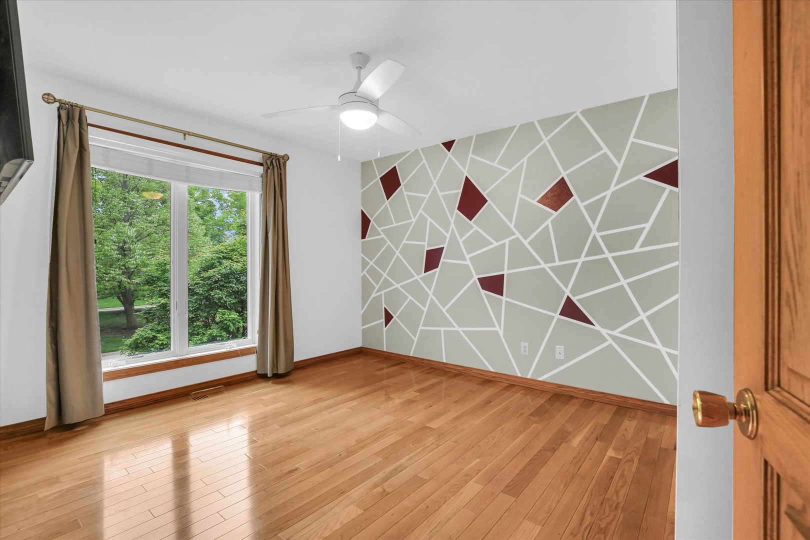 2706 North Salisbury Court Champaign, IL 61821 - Photo 11 of 60 a view of an empty room with a window and wooden floor