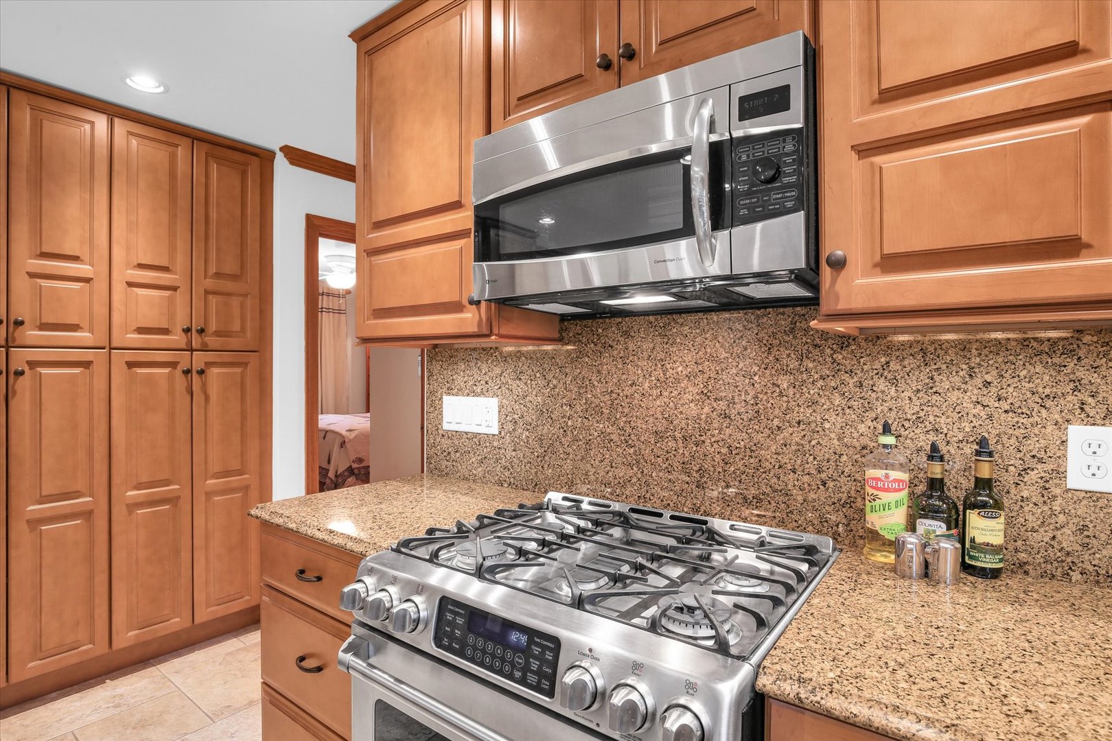 2706 North Salisbury Court Champaign, IL 61821 - Photo 25 of 60 a kitchen with stainless steel appliances granite countertop a stove and a microwave