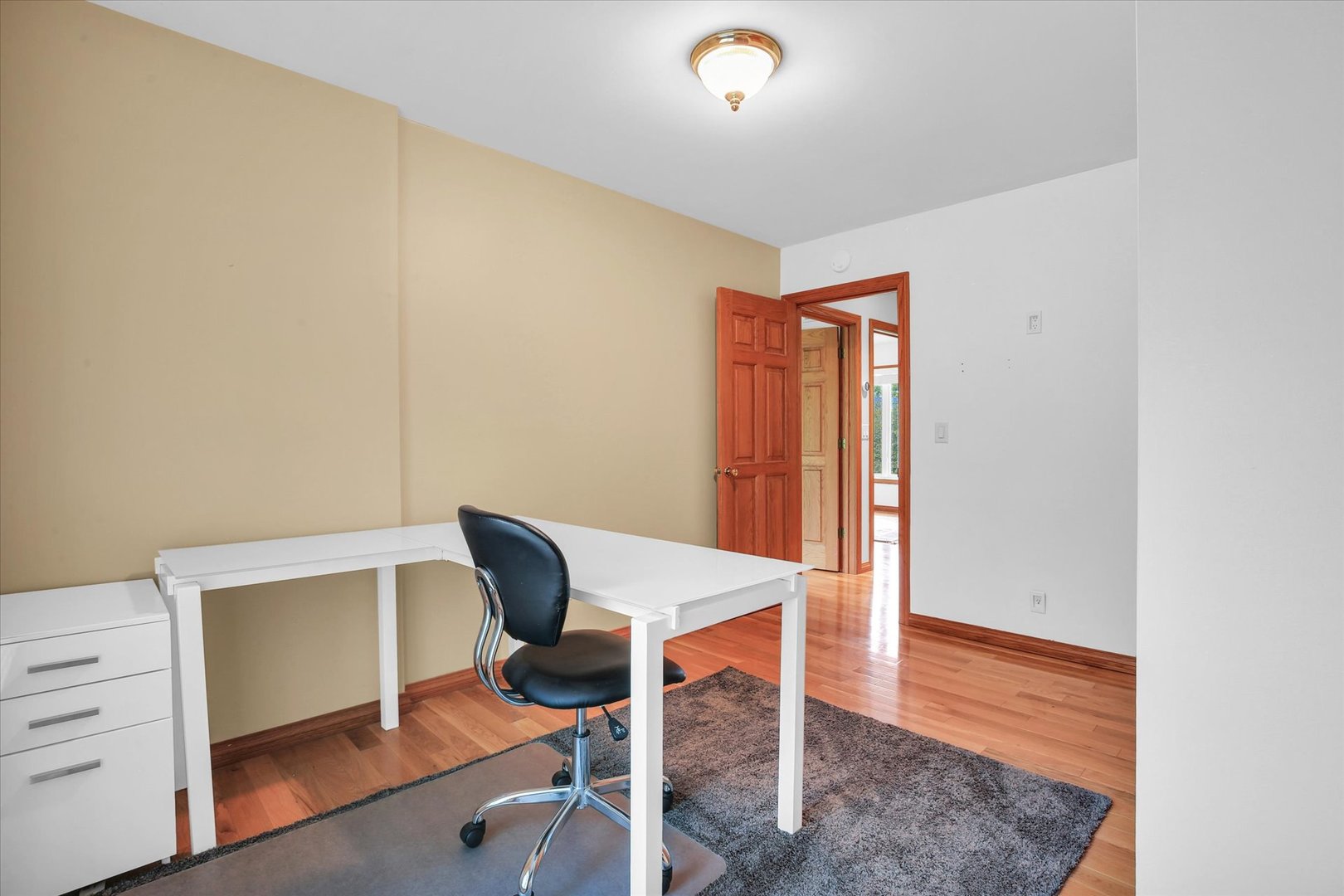 2706 North Salisbury Court Champaign, IL 61821 - Photo 40 of 60 a view of a workspace with furniture and wooden floor