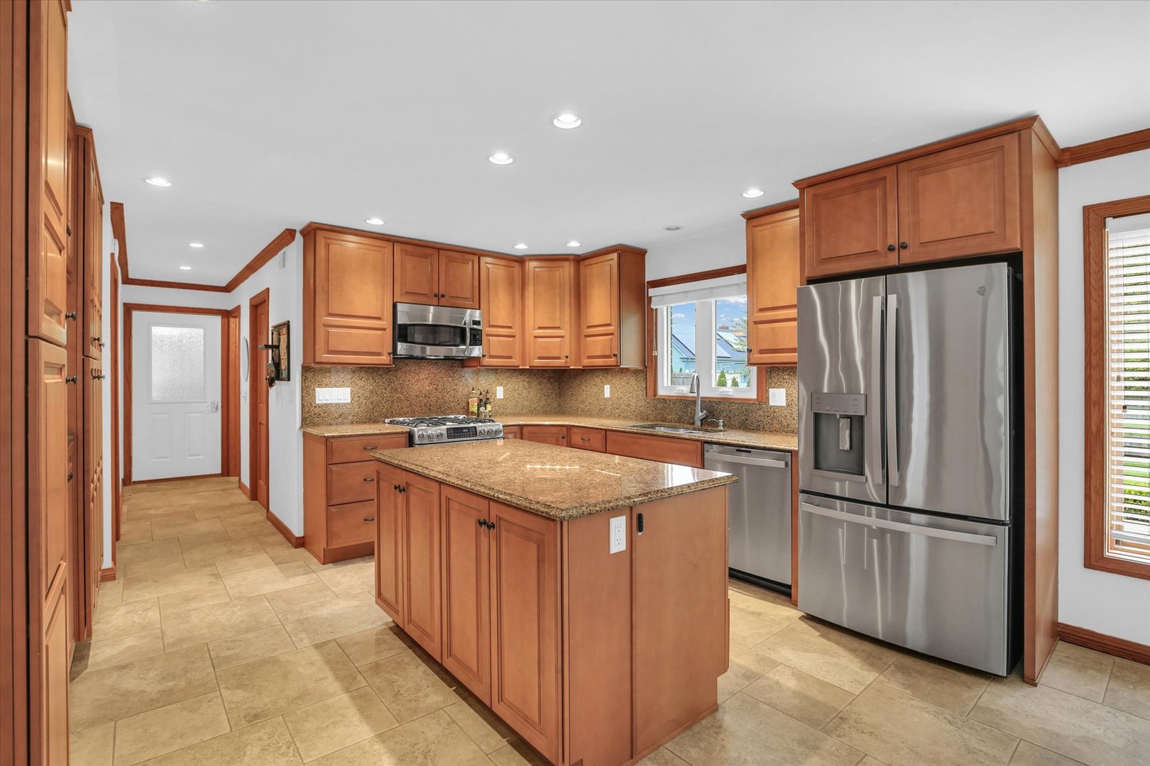 2706 North Salisbury Court Champaign, IL 61821 - Photo 5 of 60 a kitchen with stainless steel appliances granite countertop a refrigerator and a stove