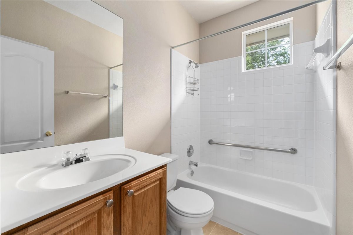 11000 Anderson Mill Road, Unit 11 Austin, TX 78750 - Photo 20 of 34 A well-appointed bathroom features a practical tub-shower combination with a bright window above.