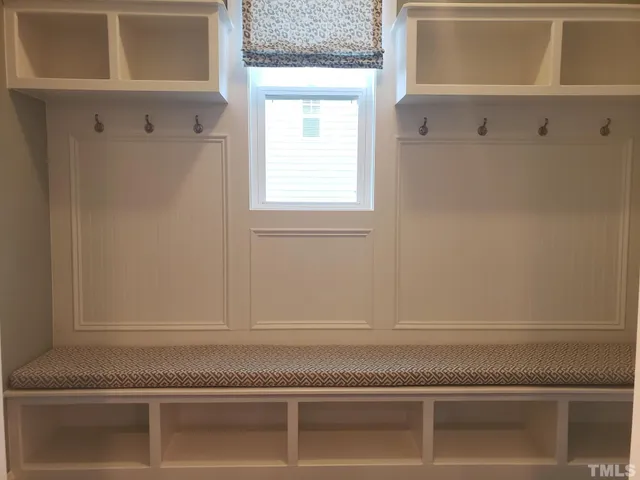 a view of wooden floor chandelier and windows in a room