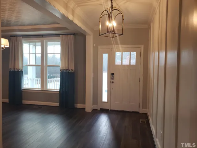 a view of a room with wooden floor and windows