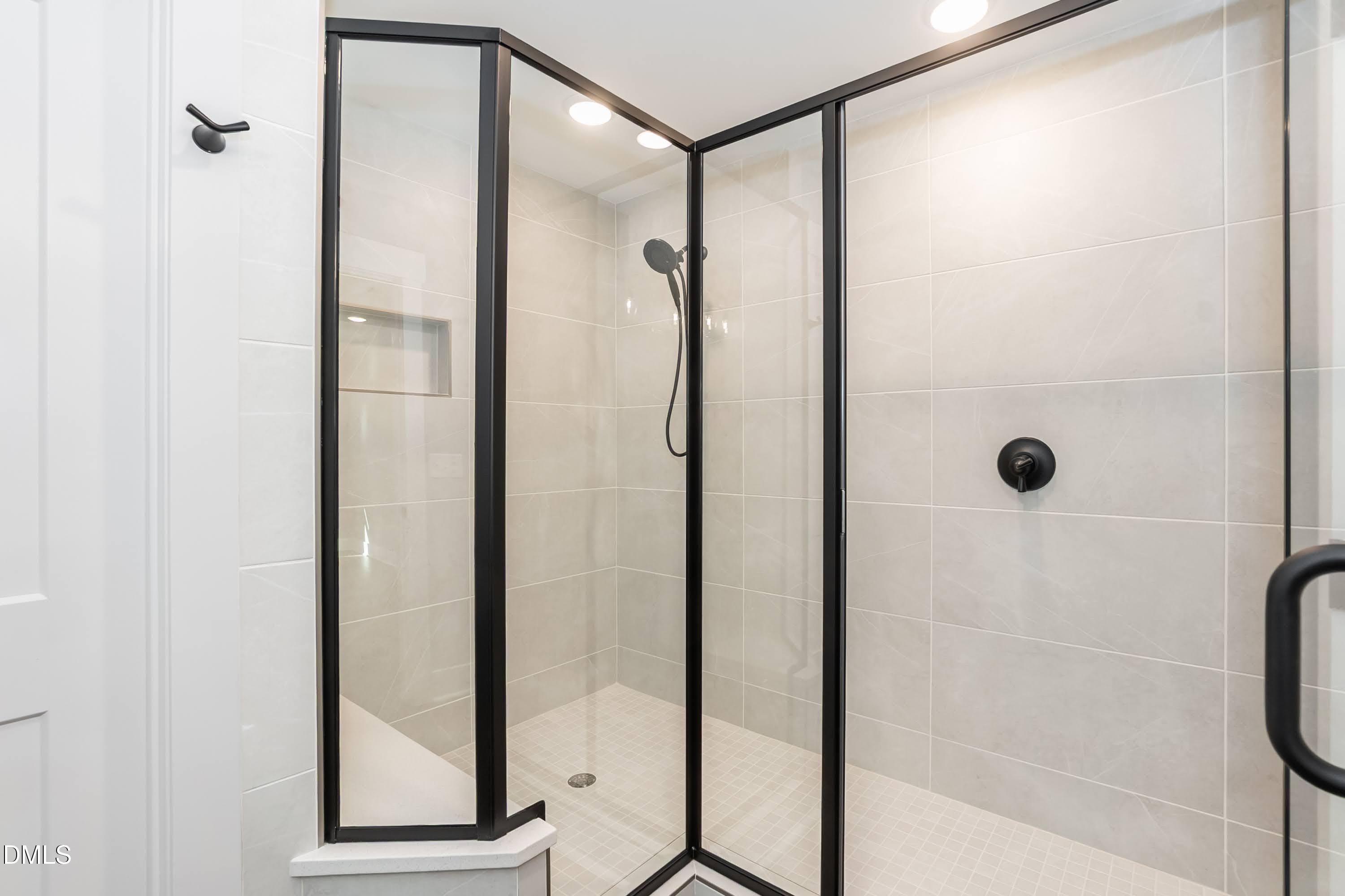 104 Buffalo Drive Spring Hope, NC 27882 - Photo 25 of 48 a bathroom with a glass shower door