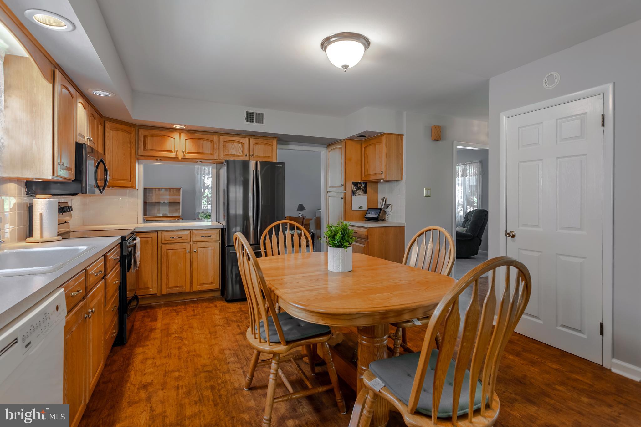 29 Strathmore Road Havertown, PA 19083 - Photo 11 of 34 a kitchen with a table chairs sink and cabinets