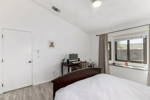 a bedroom with a large bed and furniture