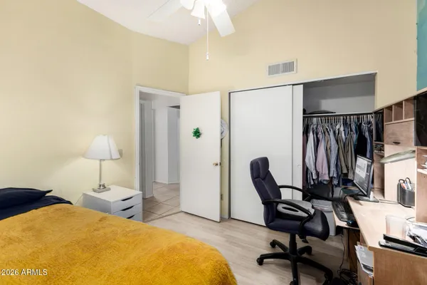 a bedroom with a bed furniture and a flat screen tv