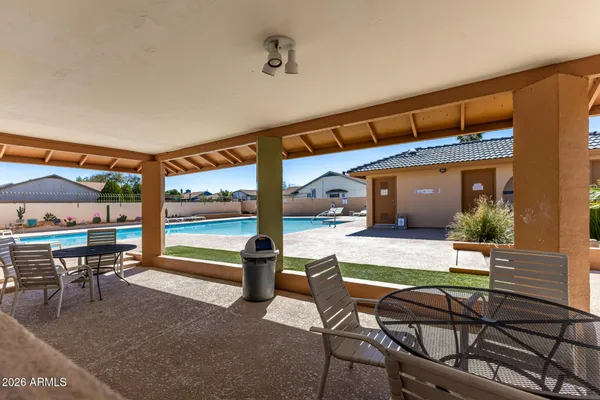 a view of a house with swimming pool and furniture