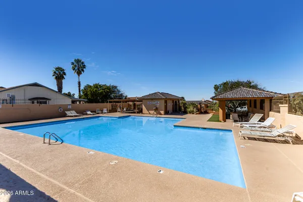 a swimming pool view with a sitting space