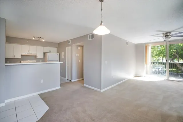 a view of a kitchen with a sink and a window