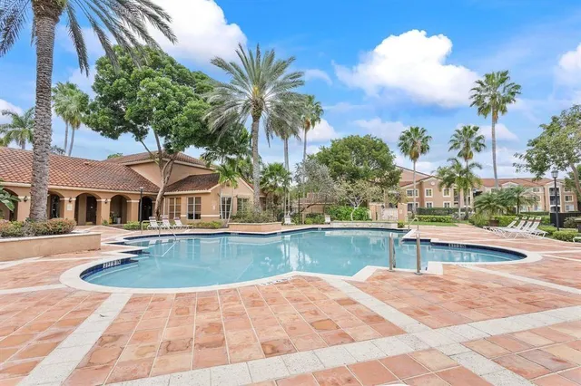 a view of a house with pool and sitting area